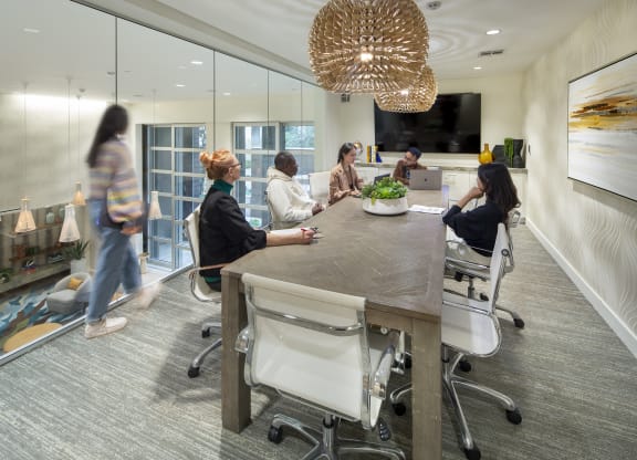 a group of people sitting around a table in an office