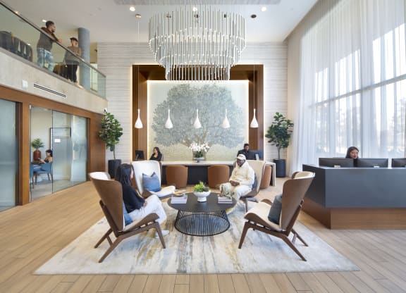 a rendering of a hotel lobby with a large chandelier and people in the background