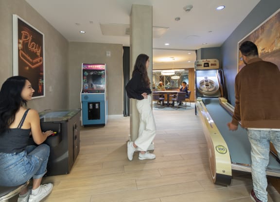 a man and a woman are standing in a room next to a bowling alley