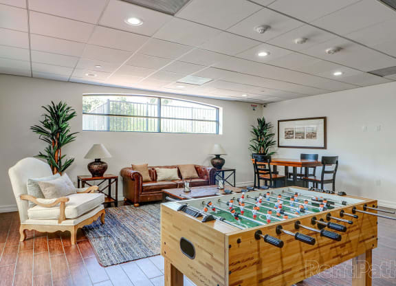 a game room with a foosball table and chairs at Le Blanc Apartment Homes, Canoga Park