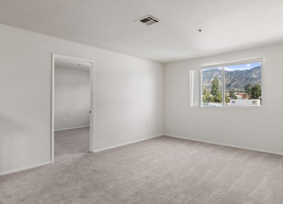 an empty room with white walls and a window with a mountain view at Dronfield Astoria California, 91342