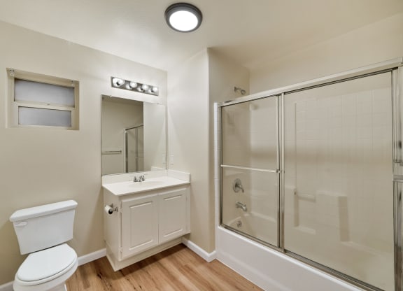 an empty bathroom with a shower toilet and sink