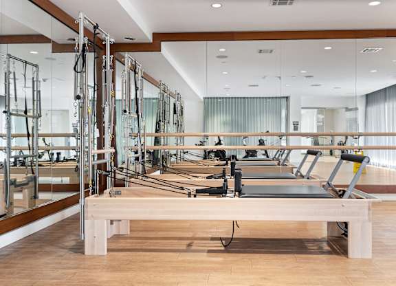 A pilates studio with mirrors on the wall.