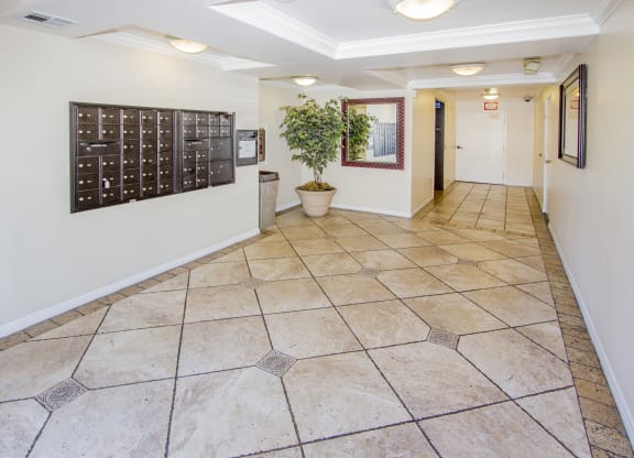 a hallway with tile floors and a calendar on the wall