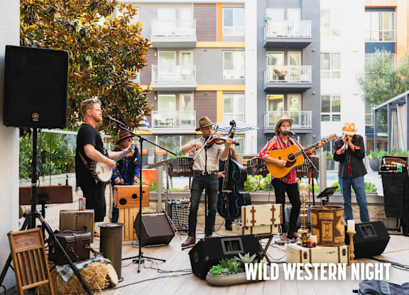 A group of people playing music on a stage with the words