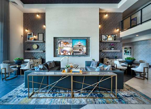 Resident clubhouse with a couch and a table at Cuvee, Glendale, AZ