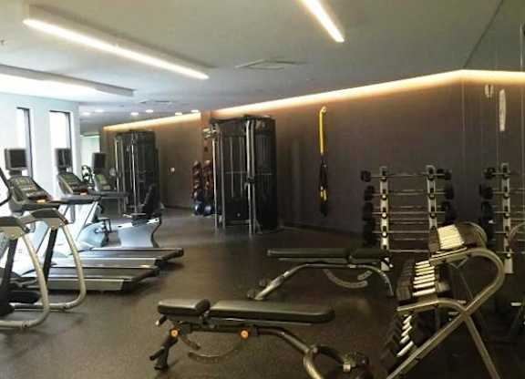 a gym with weights and other equipment on the floor