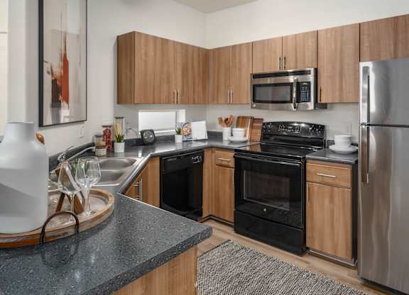 A modern kitchen with wooden cabinets and stainless steel appliances.