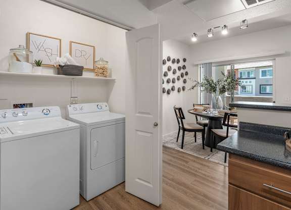 A small laundry room with a washer and dryer.