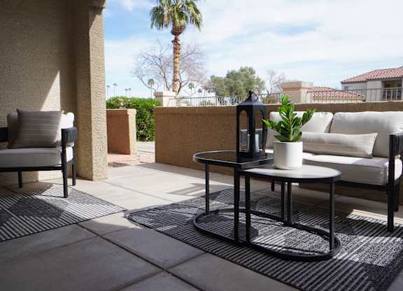A patio with a table and chairs.