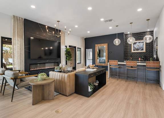 A modern living room with a fireplace and a television.