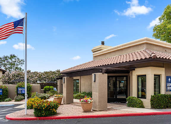A building with a flag on a pole in front of it.