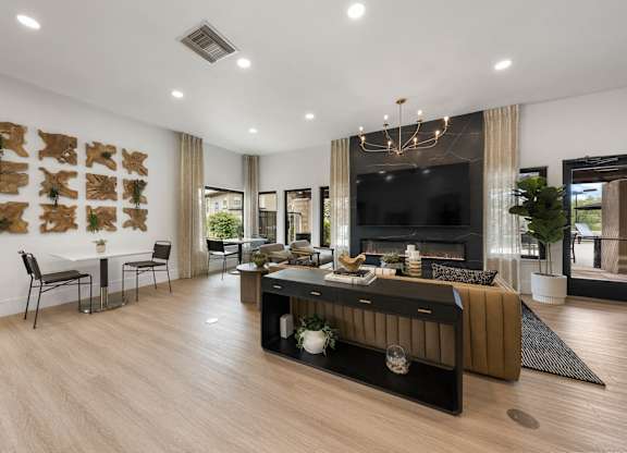A modern living room with a fireplace and a TV.