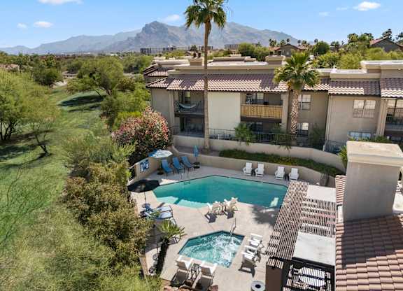 A pool and patio area with a mountain in the background.