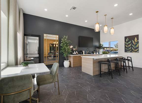 A modern kitchen with a dining table and chairs.