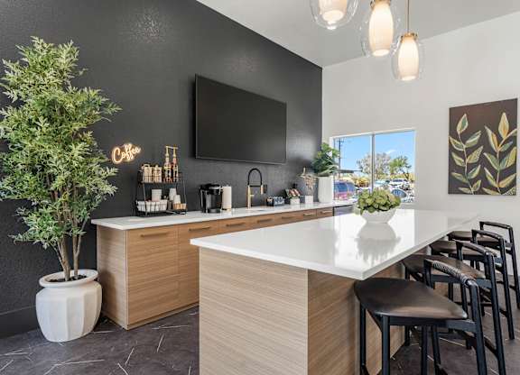 A modern kitchen with a white countertop and wooden cabinets.