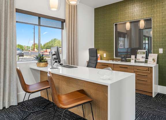 A room with a desk, chair, and a mirror.