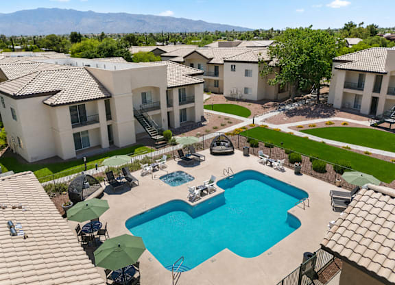 A swimming pool surrounded by apartment buildings.