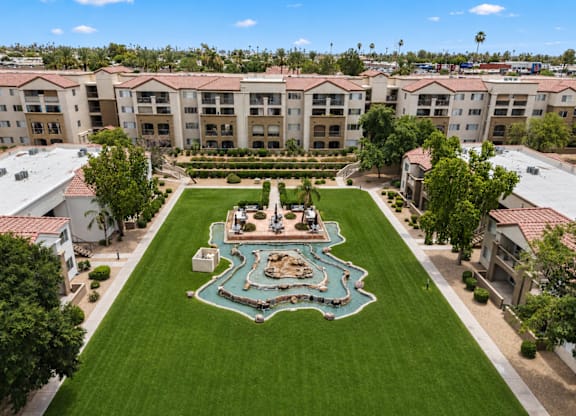 A courtyard with a fountain surrounded by buildings.