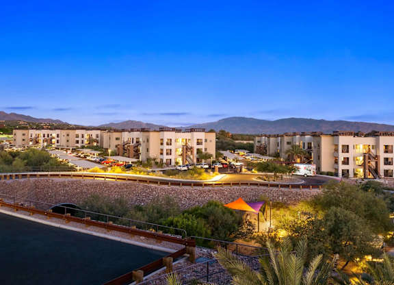 A resort with a pool and a mountain in the background.