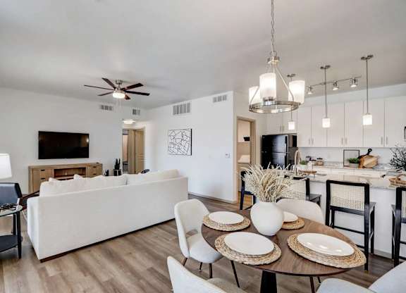 A modern living room with a white couch and a wooden coffee table.