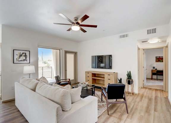 A living room with a white couch and a television.