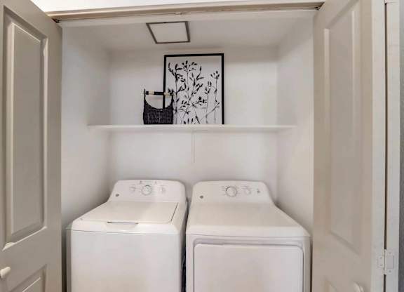 A small laundry room with two washing machines.