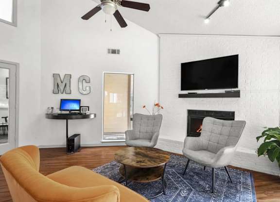 A living room with a yellow chair and a coffee table.
