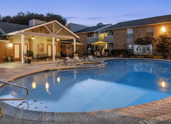 A swimming pool in a backyard with a house in the background.