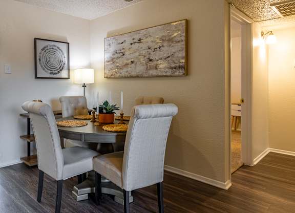 A dining room with a table and chairs.