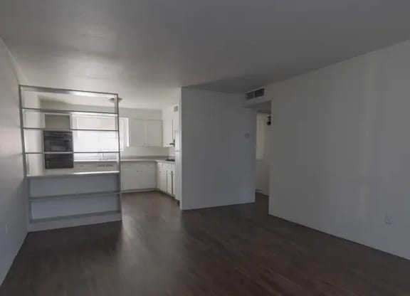 A room with wooden floors and white walls.
