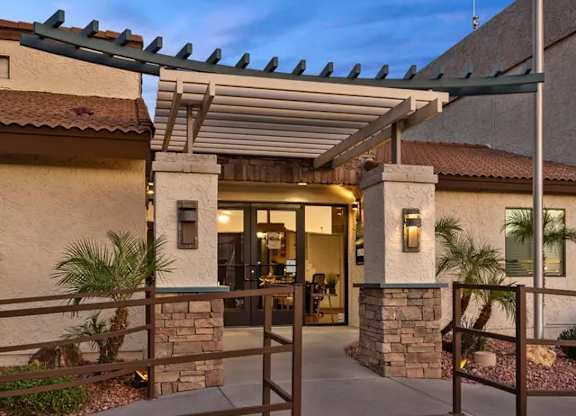 A building with a stone pillar and a glass door.