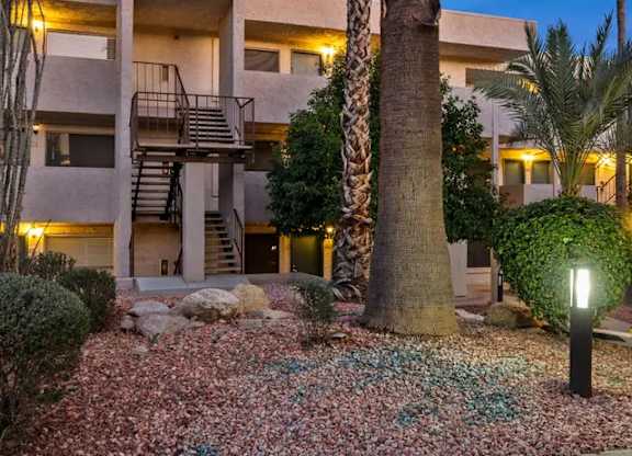 A building with a palm tree in front of it.