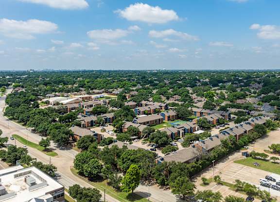 A bird's eye view of a residential area with houses and trees.