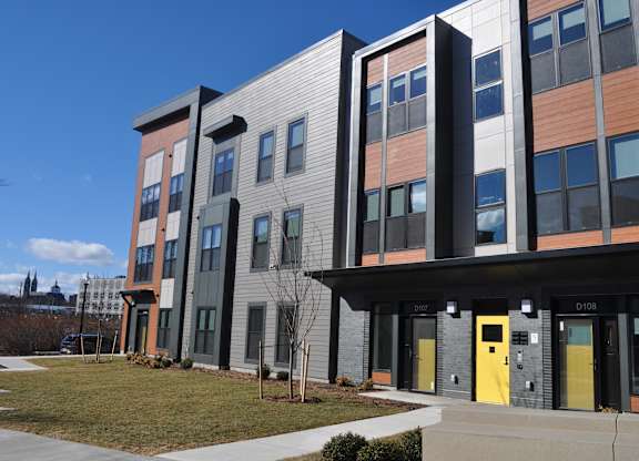 the exterior of a building with yellow doors