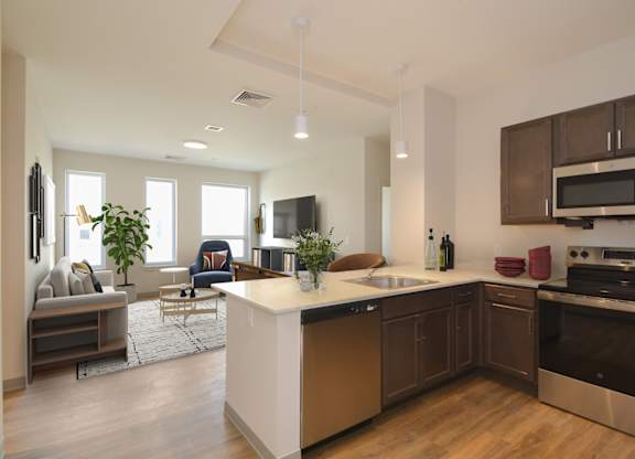 A modern kitchen with a large island and stainless steel appliances.