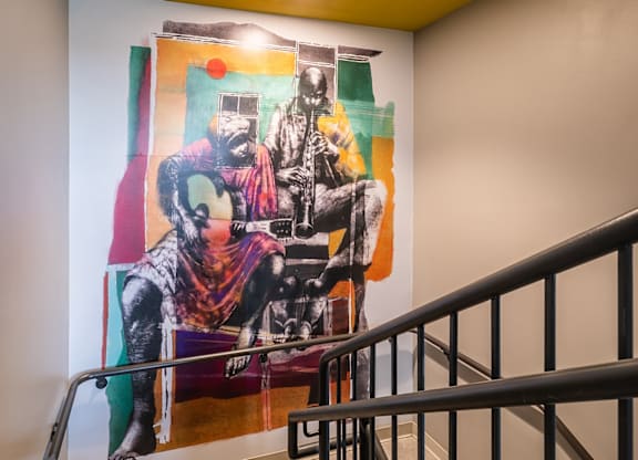 A painting of a man with a gun is on the wall.