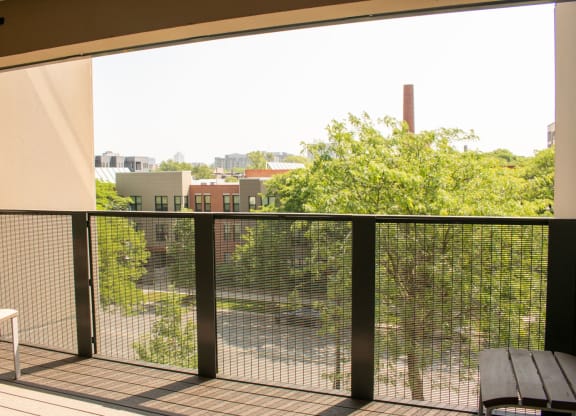 a balcony with a bench and a view of the city