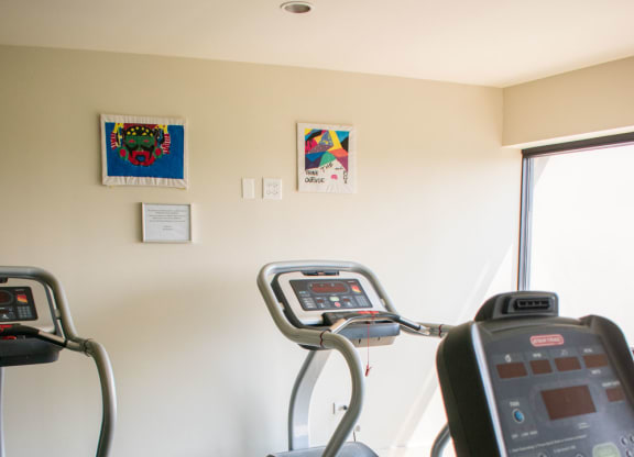 a room with two treadmills and two exercise bikes