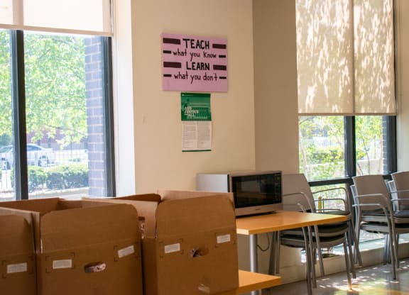 a room with cardboard boxes and a computer on a table