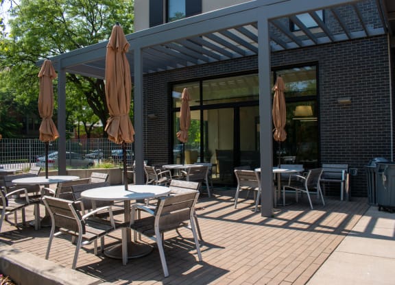 a patio with tables and chairs
