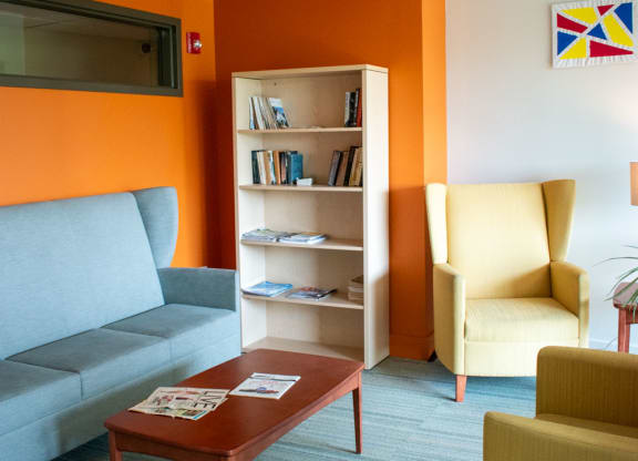 a living room with orange and white walls