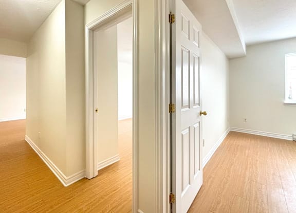 A room with a white door and a window.