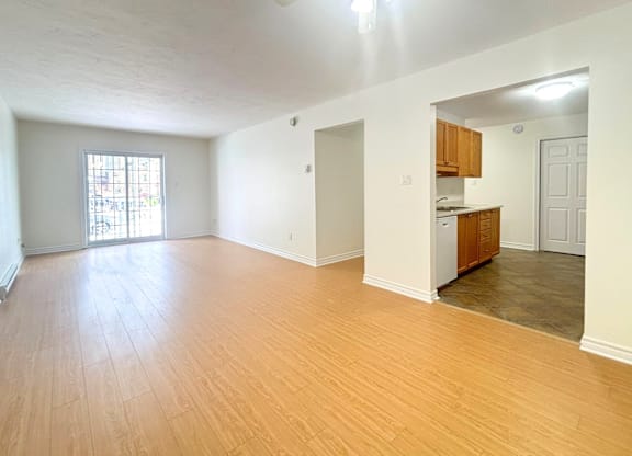 A room with wooden floors and a ceiling fan.