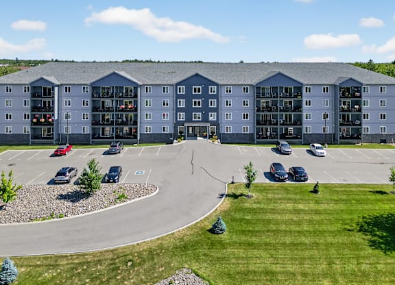 A large building with a parking lot in front of it.