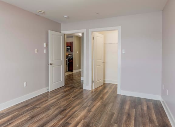 A room with a wooden floor and white walls.