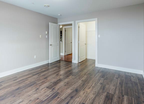 A room with wooden floors and white walls.