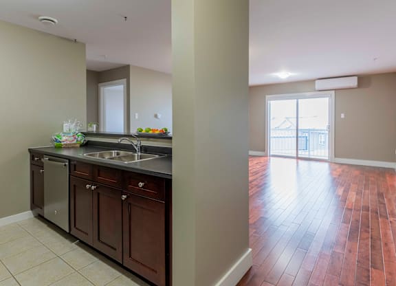 A kitchen with brown cabinets and a tiled floor.