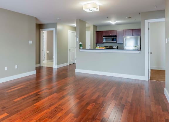 A kitchen area with a microwave, oven, and refrigerator.