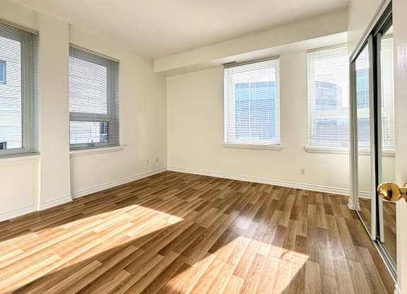 A room with wooden flooring and white walls.
